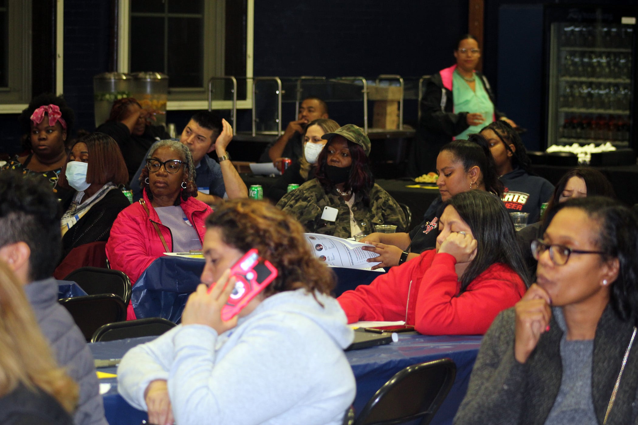 Parents sit at tables in a school gymnasium in Chicago.