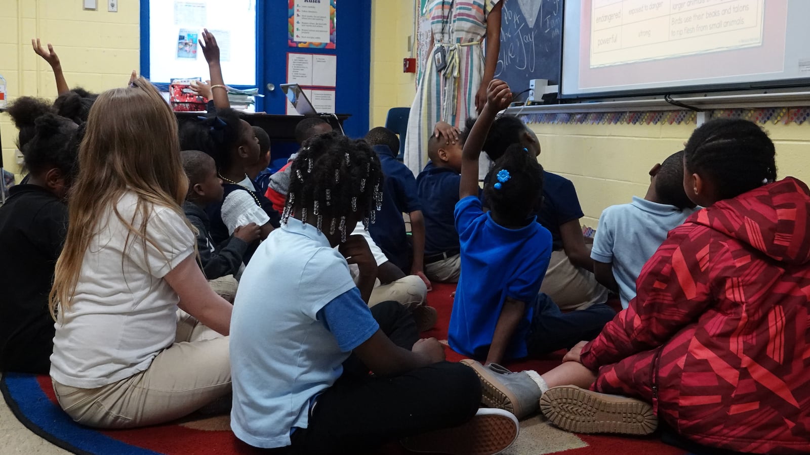 Students raise their hands in a classroom at Gardenview Elementary School in Memphis in this file photo from May 2019.