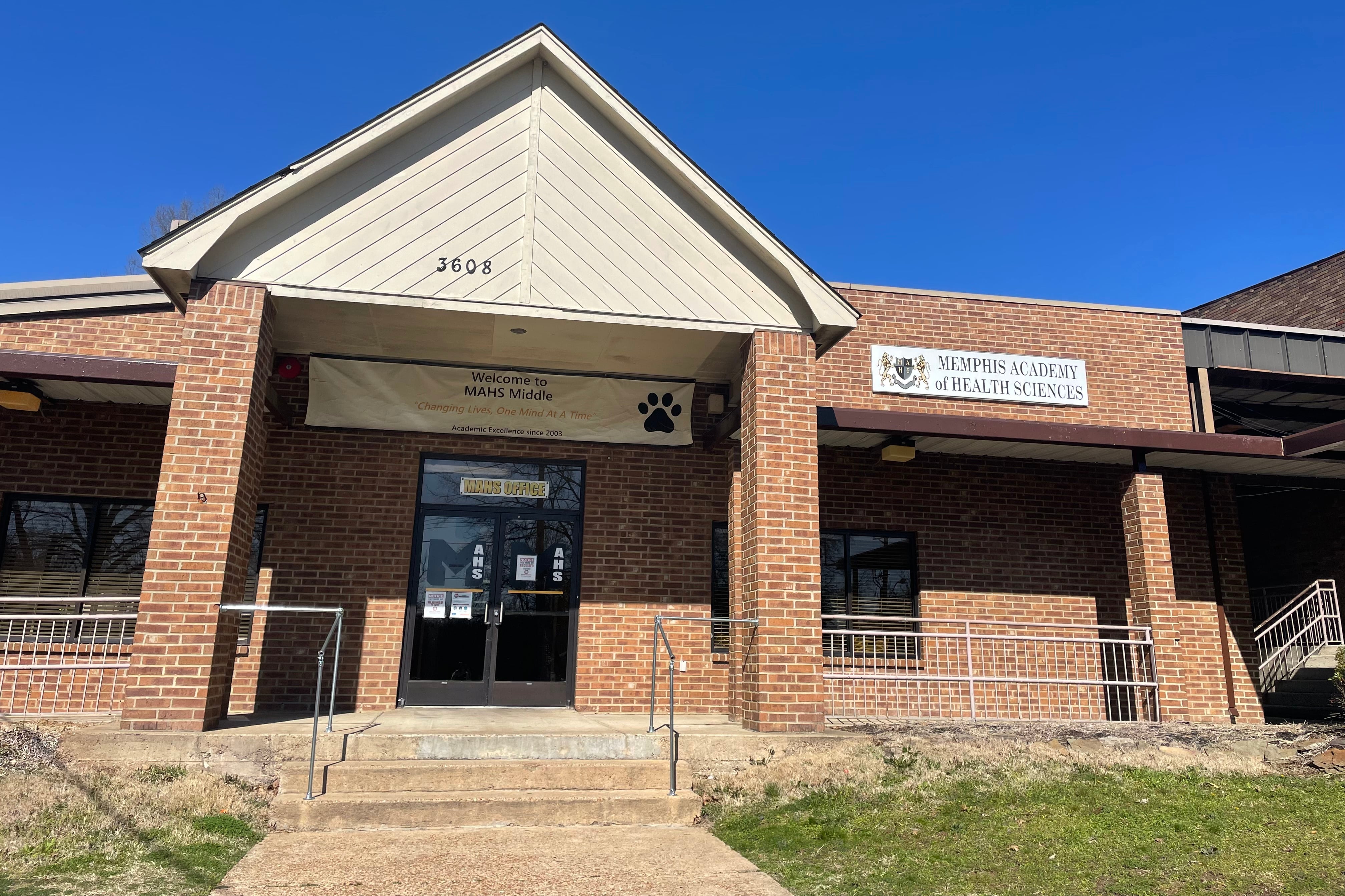 The entrance to a school building built with brown bricks