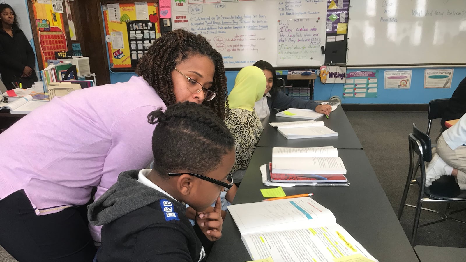 Kenya Posey stops to give one-on-one help to a student during a recent lesson.