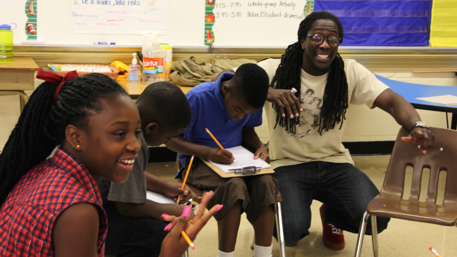 Freedom School teacher Lozie Guy (right) walks his class through an exercise where they build their own family trees during the summer learning program at Frayser Achievement Elementary School in Memphis.