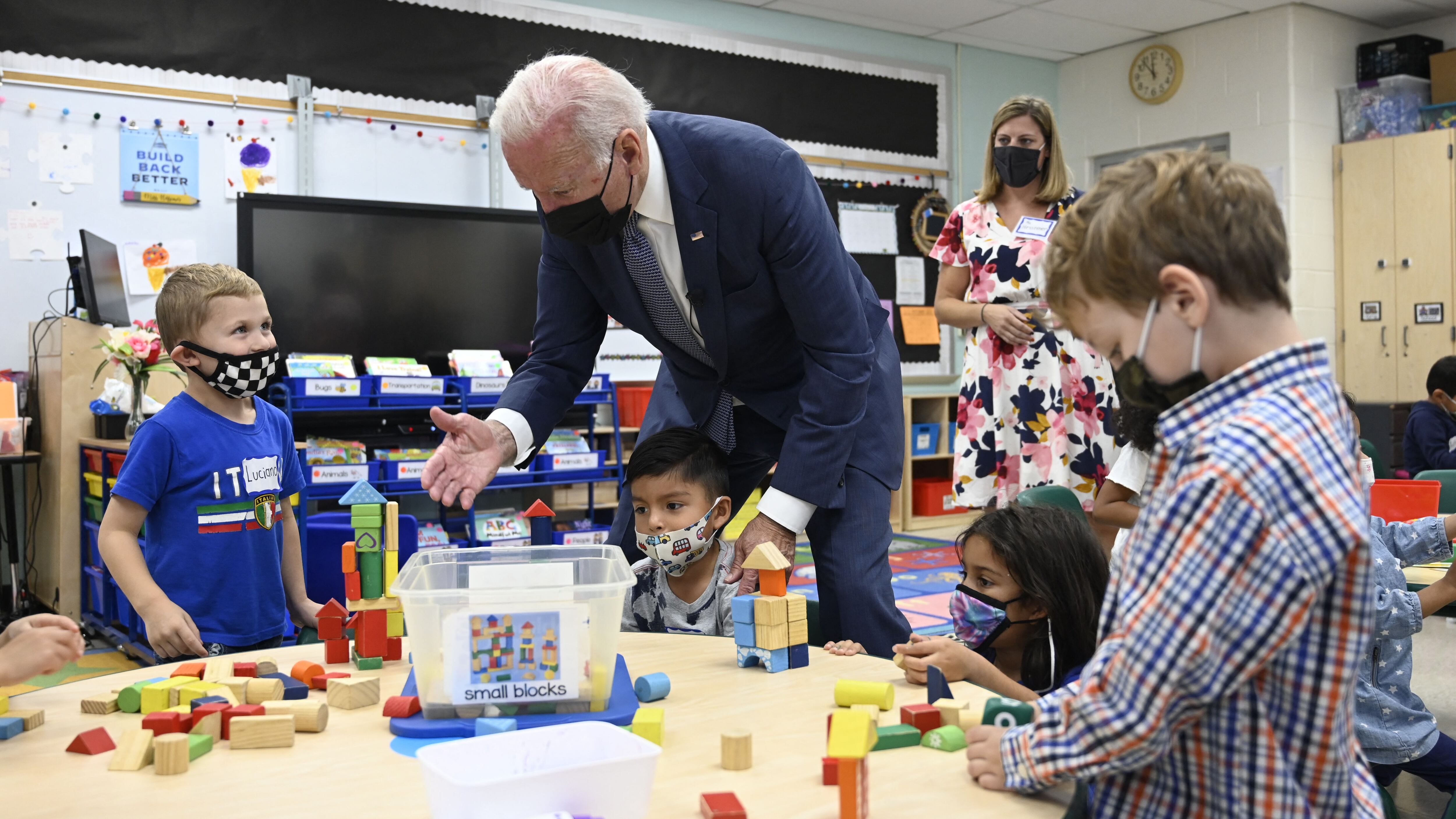 President Joe Biden meets with young students during a school visit.