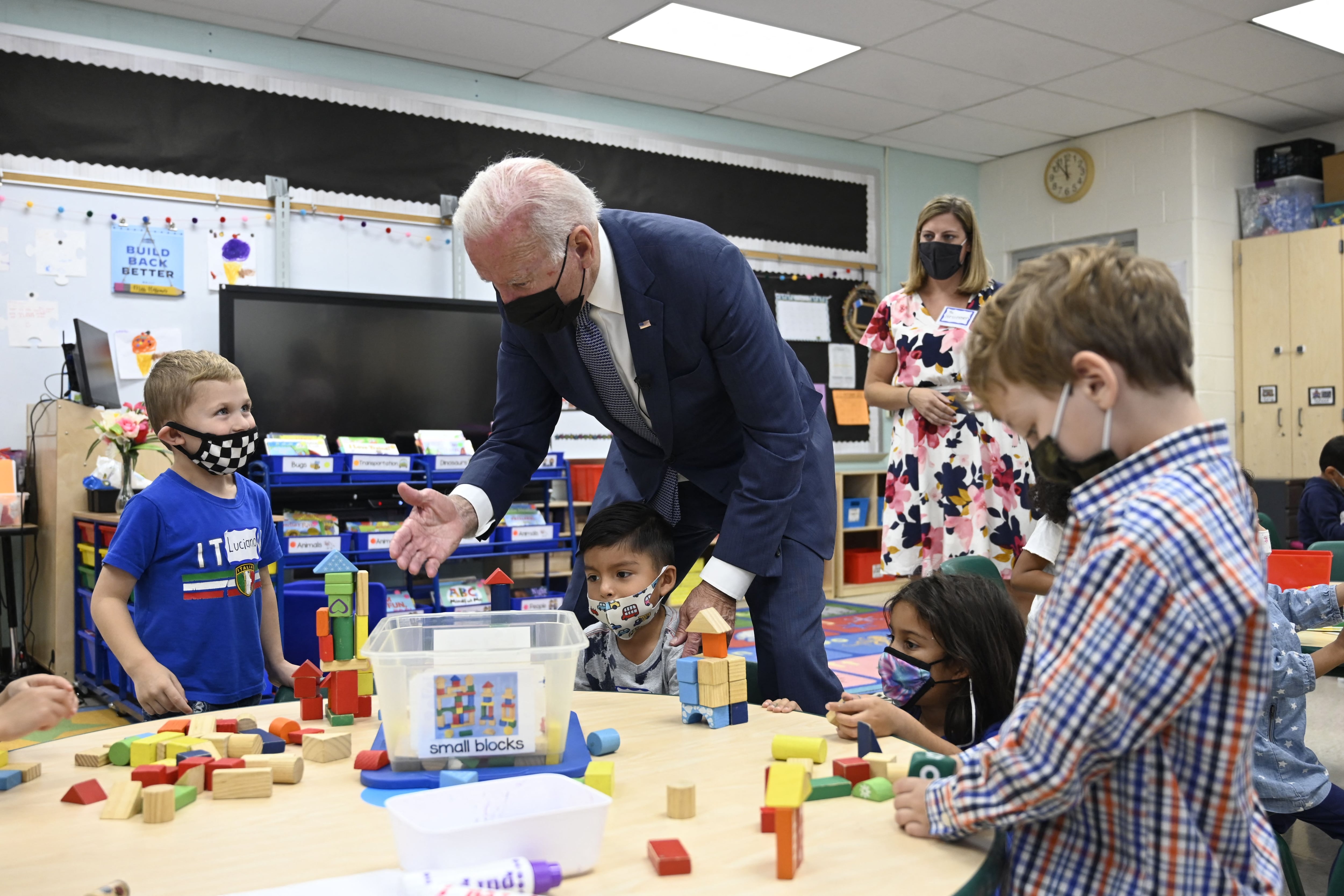 President Joe Biden meets with young students during a school visit.