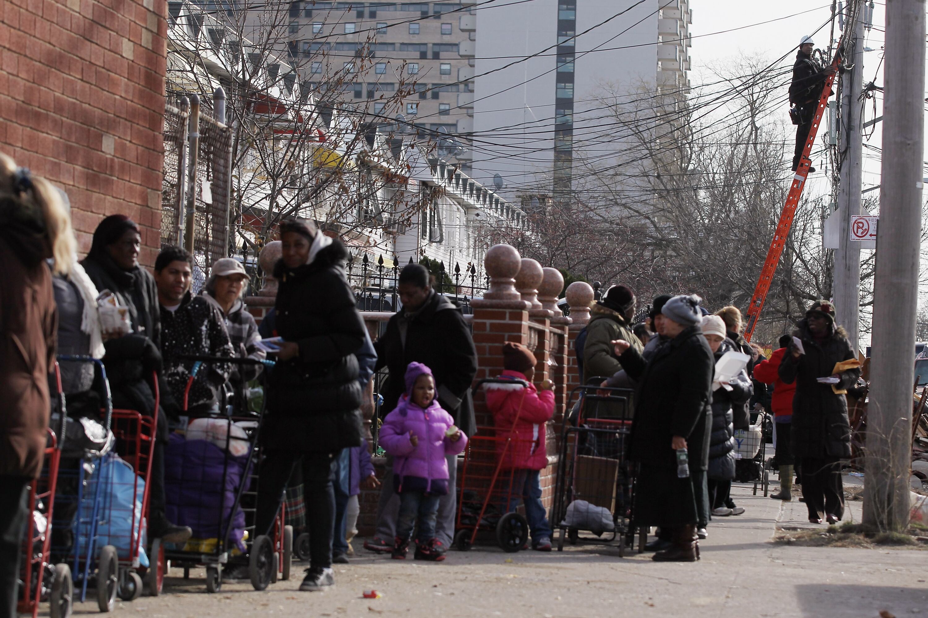 People wait on line in winter coats to obtain food and other items from a distribution point in the Coney Island neighborhood on Nov. 20, 2012.