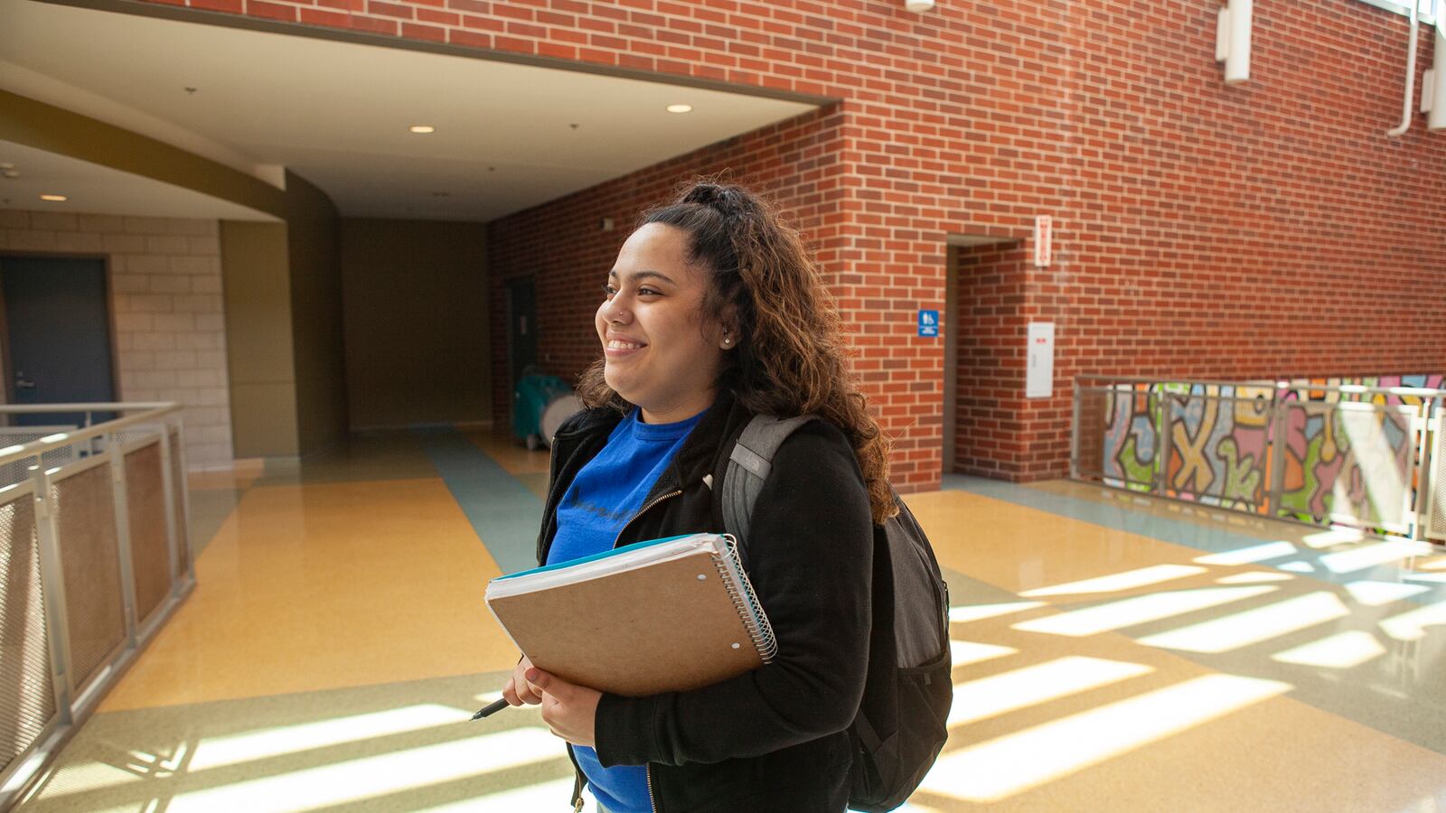 Itzayanna walks in the hallway at North Grand High School in Chicago. Photo by Stacey Rupolo/Chalkbeat; taken May, 2019