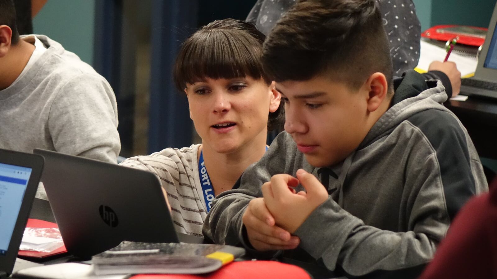 Seventh grade science teacher Sharena DelBrocco works with a student at Fort Logan Northgate in the Sheridan school district.