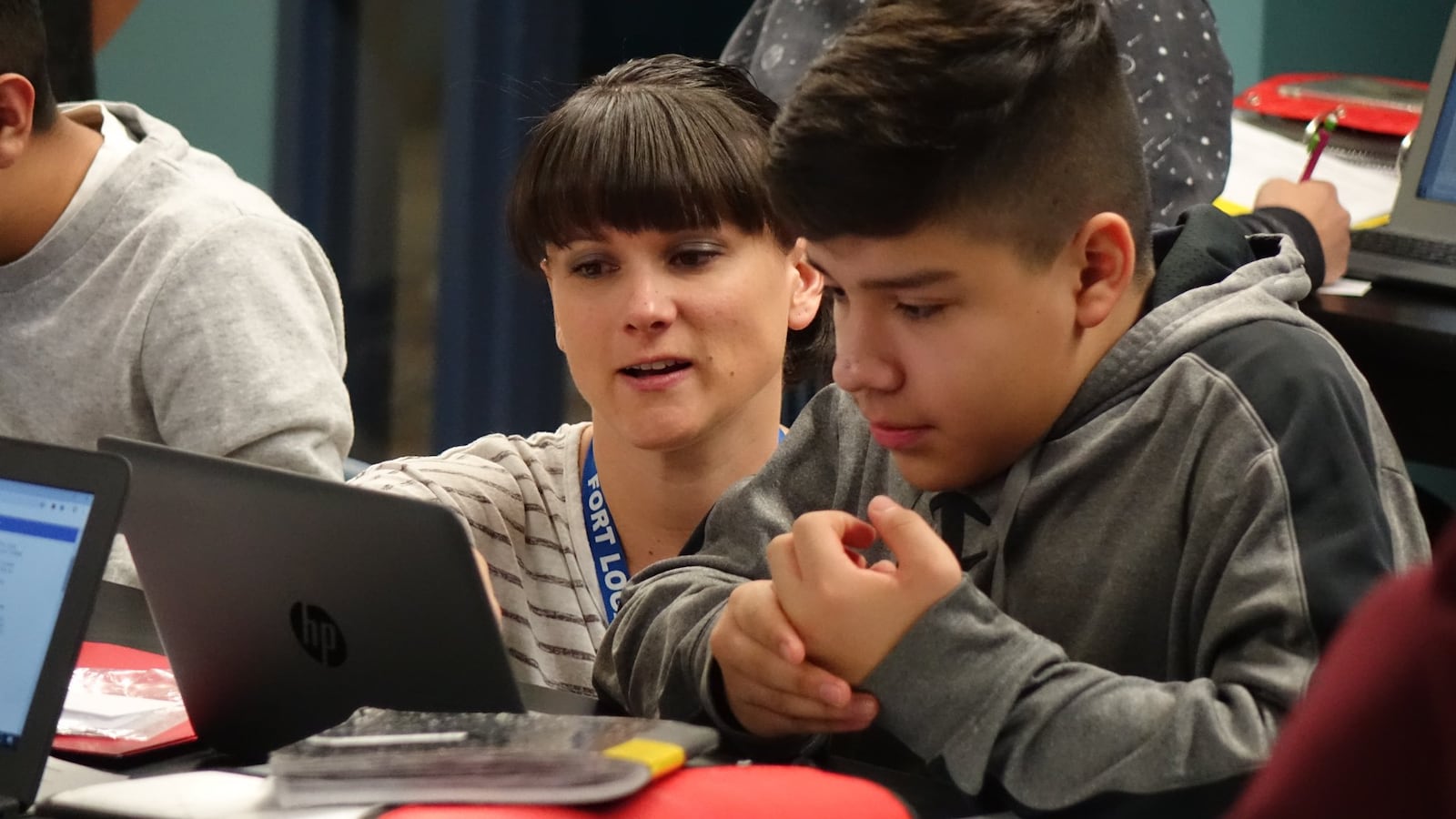 Seventh grade science teacher Sharena DelBrocco works with a student at Fort Logan Northgate in the Sheridan school district.