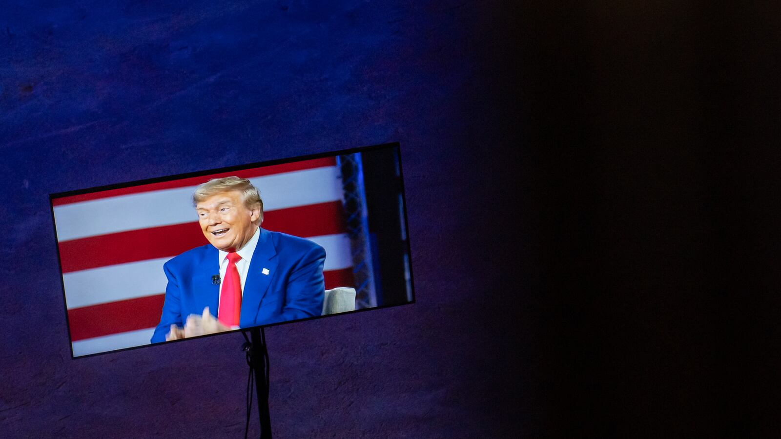 On a TV screen, President Donald Trump speaks at a townhall.