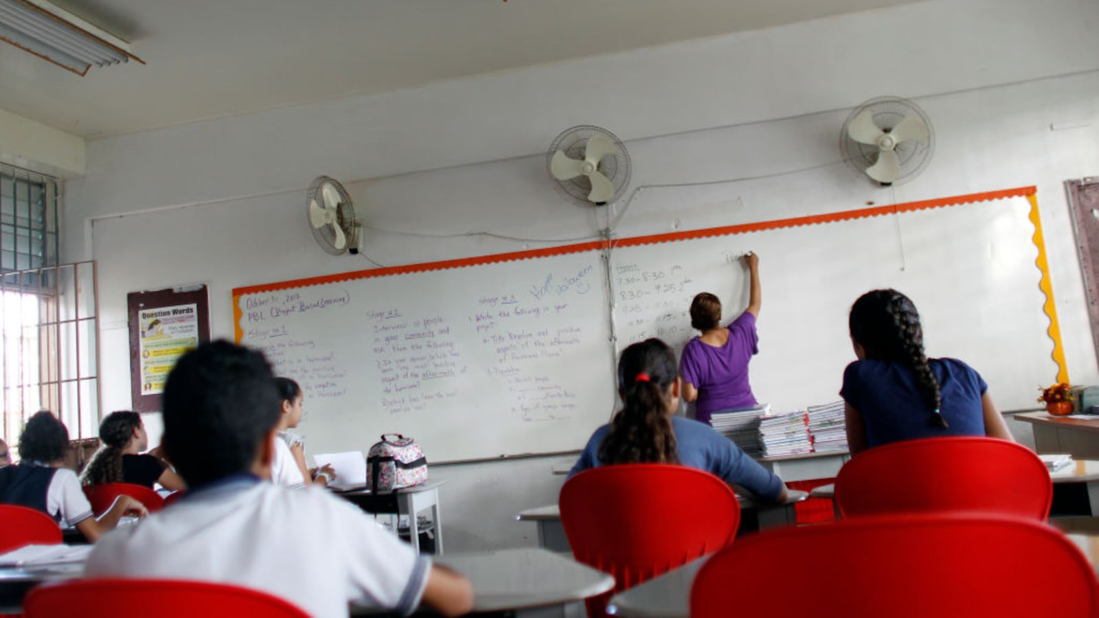 Joan Rodriguez teaches English class to her 6th grade students at the Sotero Figueroa Elementary School in San Juan, Puerto Rico, November 6, 2017.The school reopened its doors without electricity to receive students 46 days after Hurricane Maria hit the island. (RICARDO ARDUENGO/AFP/Getty Images)