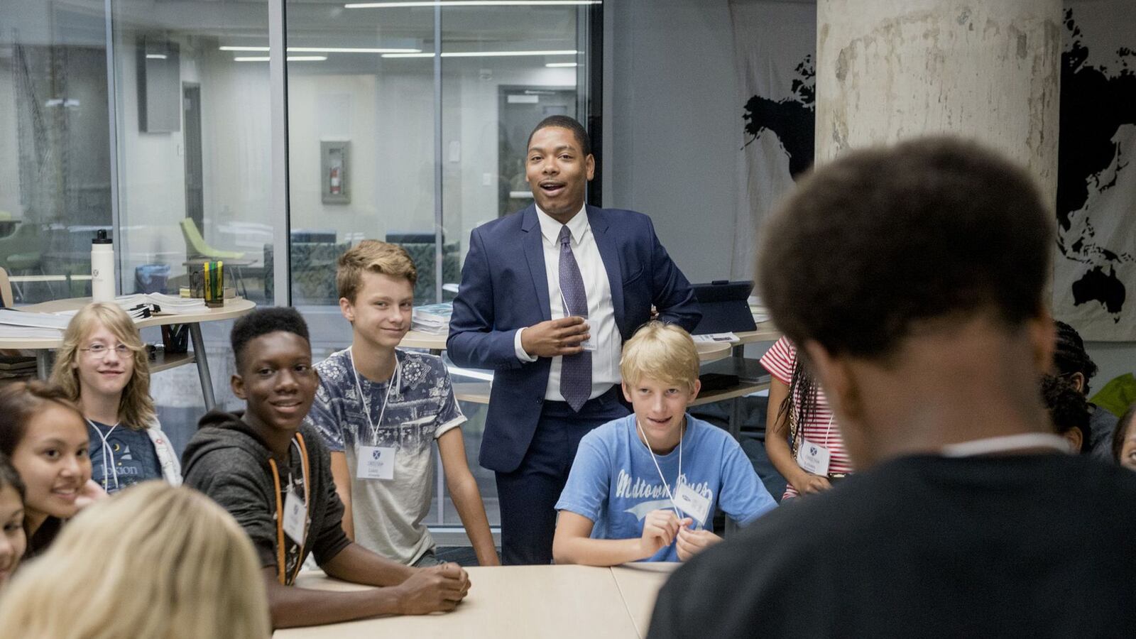 Teacher Deion Jordan speaks with Crosstown High School's inaugural ninth grade class on the first day of school. He will now serve as the director of competencies at the school.