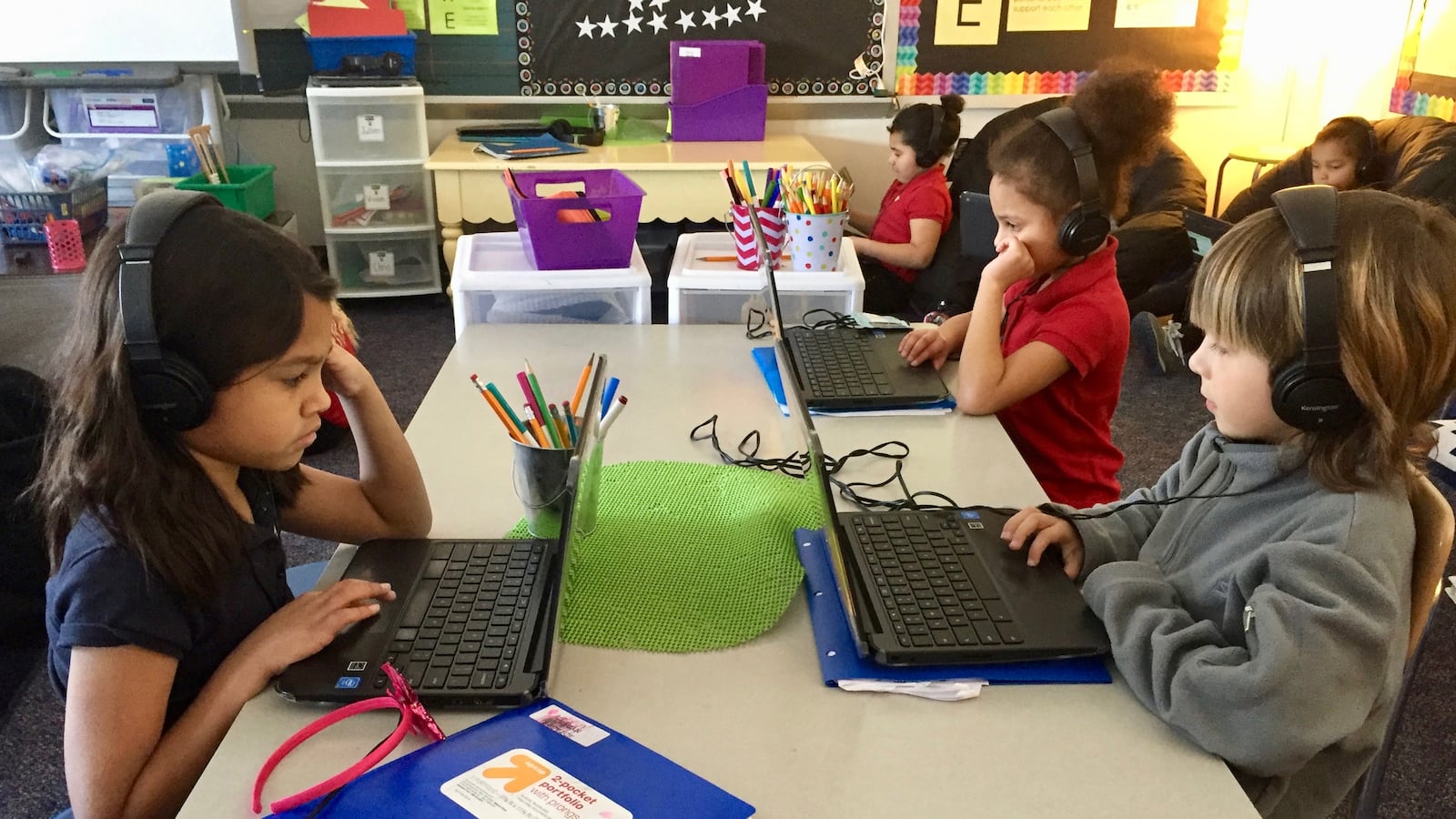 First-grade students work on English and math skills.