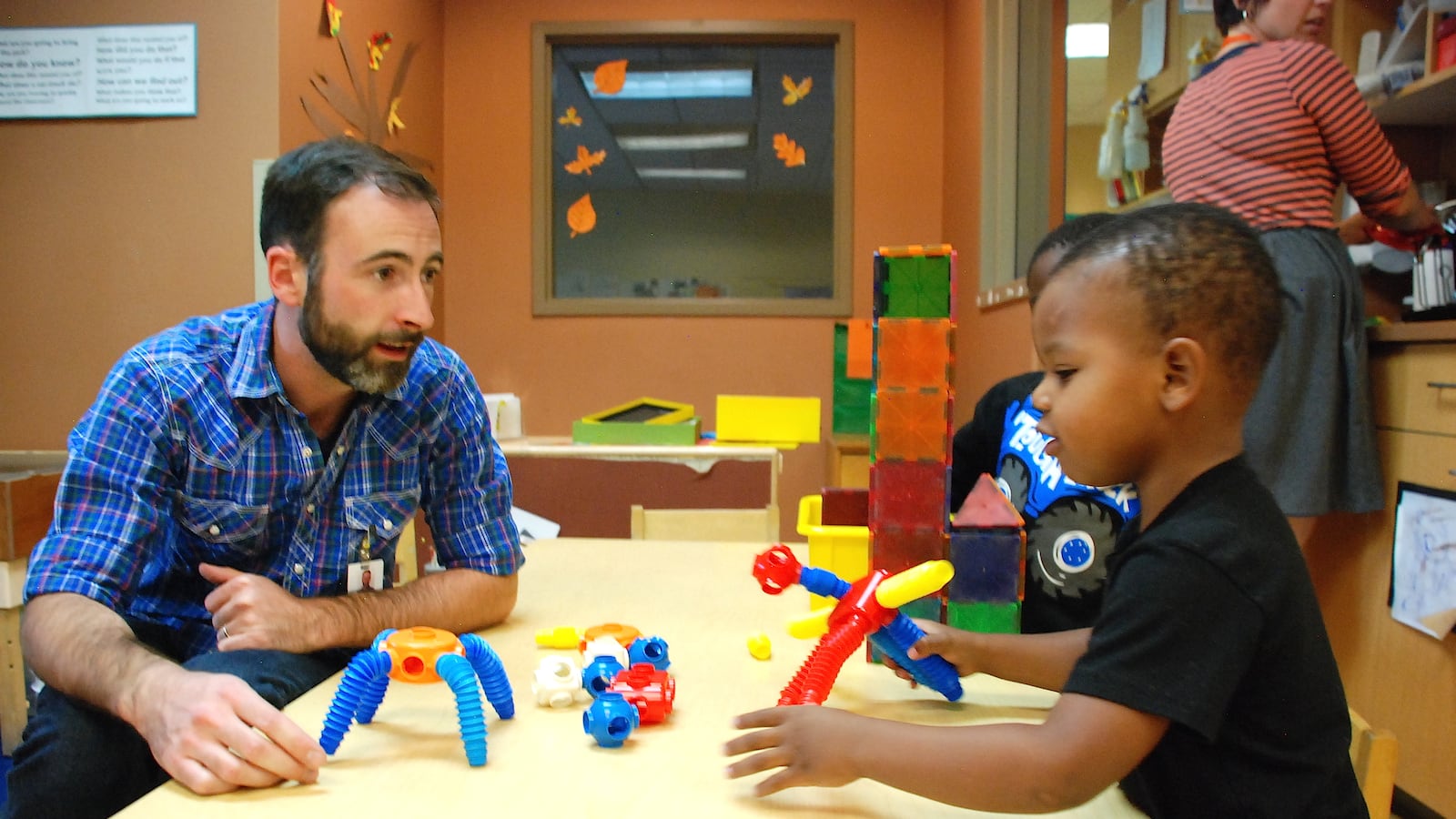 A staff member works with preschoolers at Educare Denver at Clayton Early Learning.