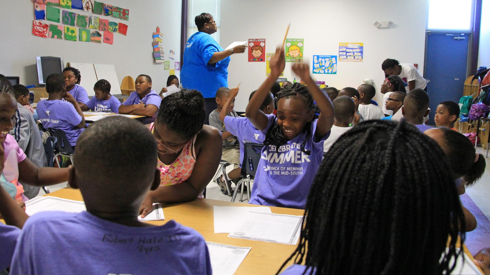 Kayla Terrell, 8, reacts to getting a question correct on her reading worksheet.