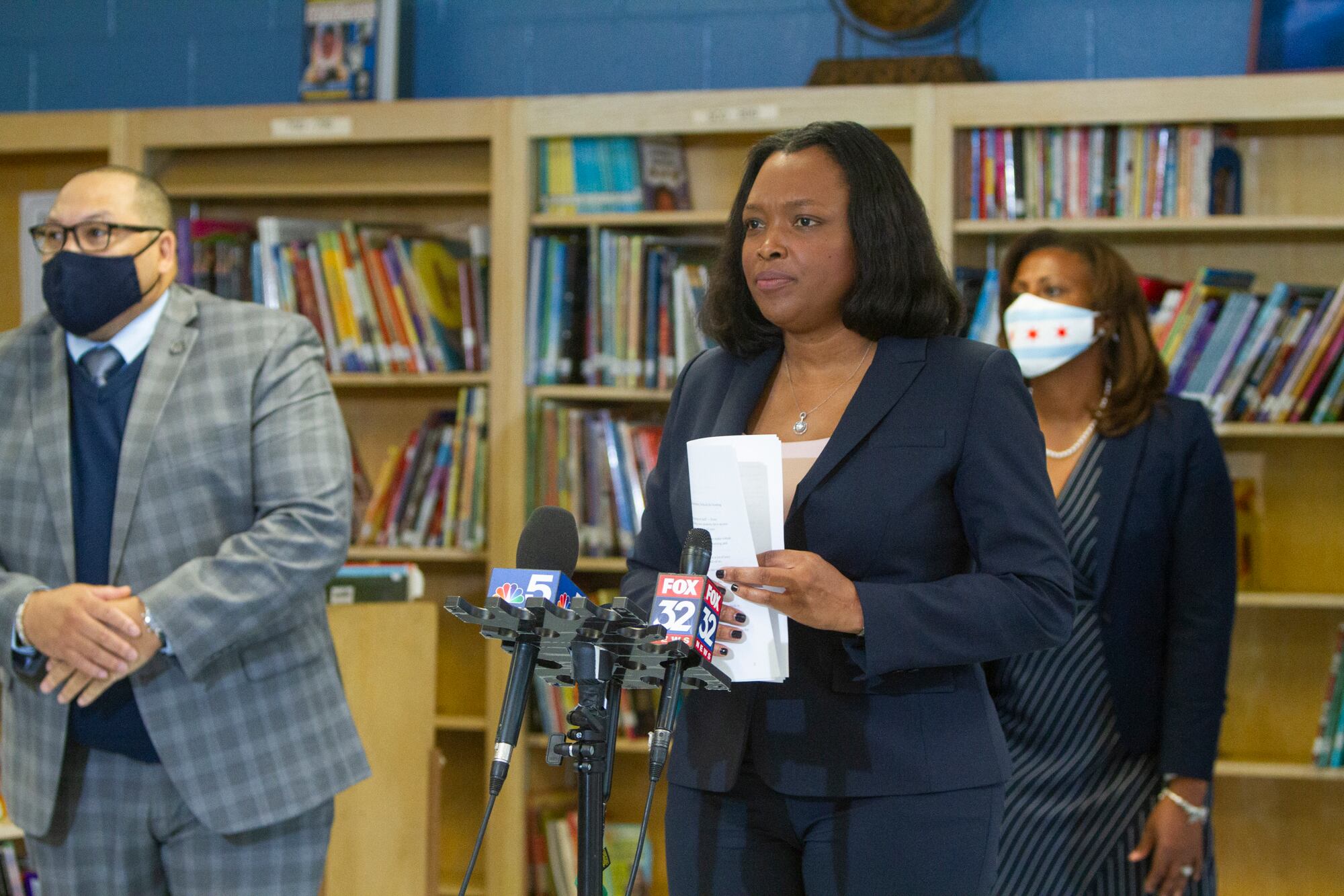 School chief Janice Jackson standing by a microphone.