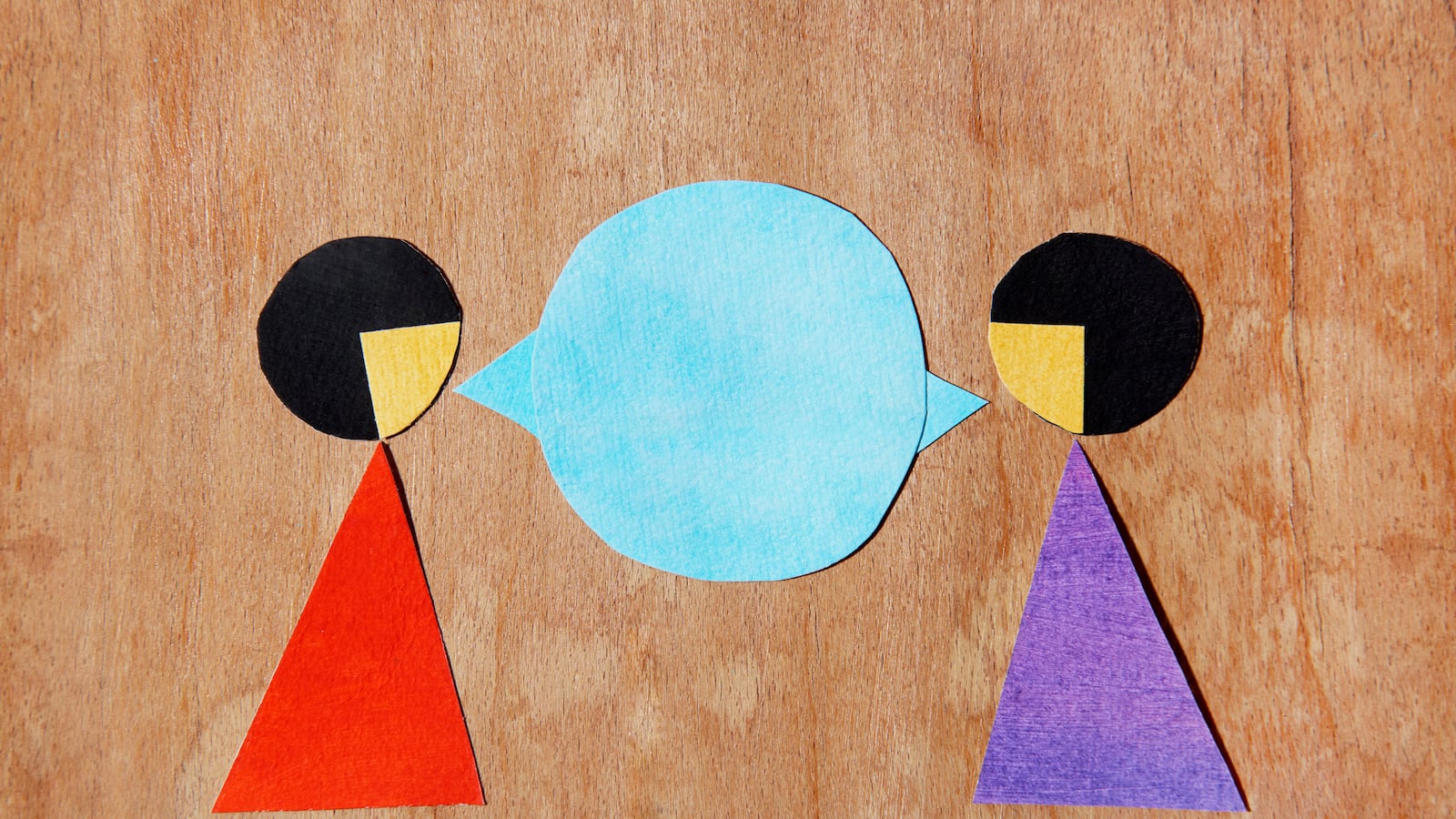 A felt depiction of two women talking