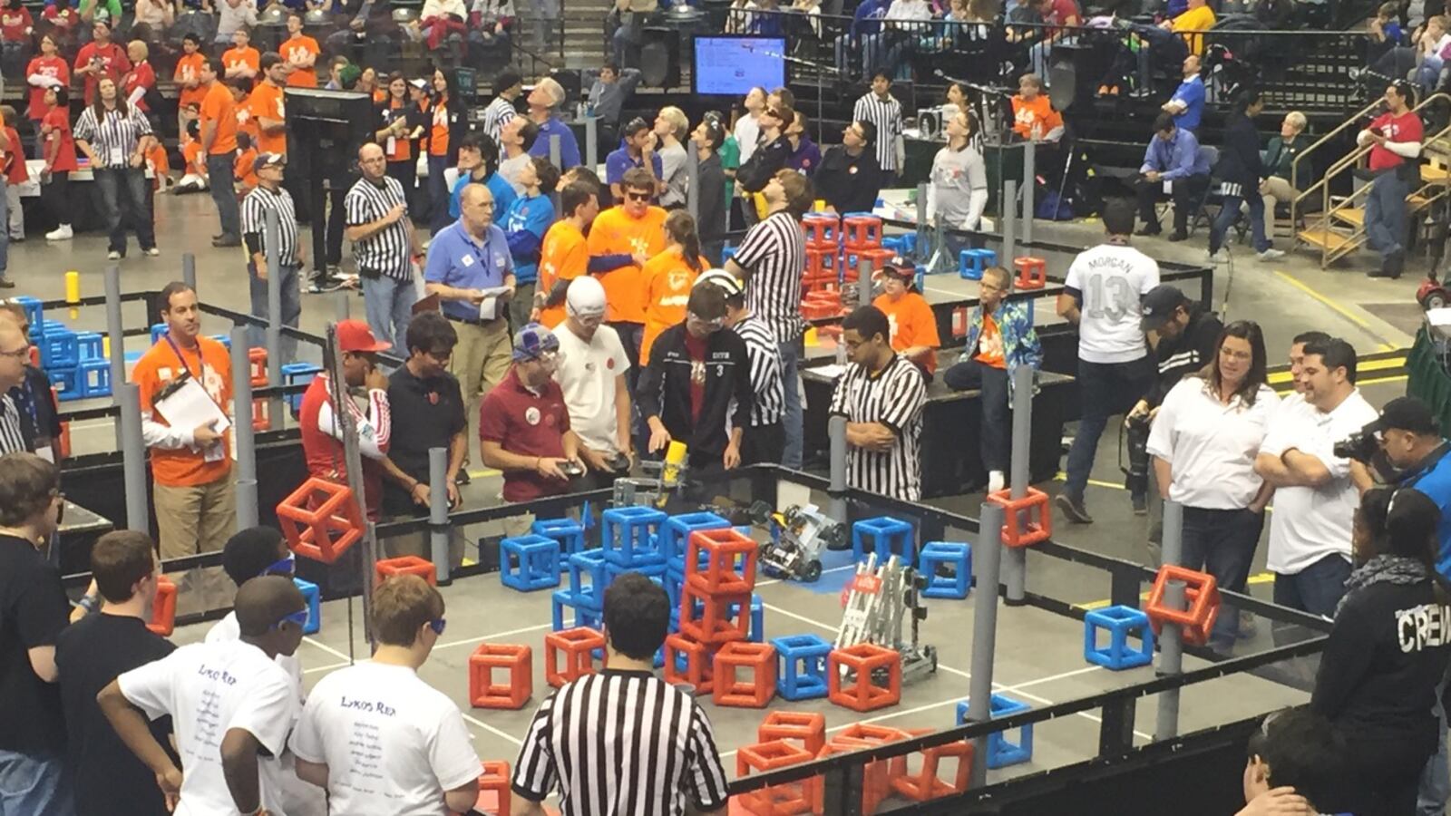 Providence Cristo Rey High School's robotics team competes in the VEX tournament Sunday. The goal of the challenge is to stack cubes on the gray goalposts or build towers in the arena.