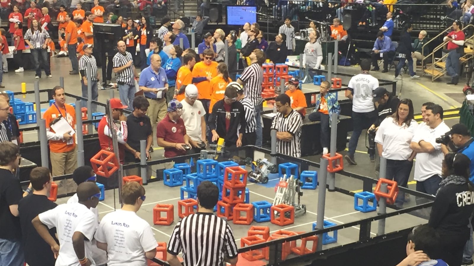 Providence Cristo Rey High School's robotics team competes in the VEX tournament Sunday. The goal of the challenge is to stack cubes on the gray goalposts or build towers in the arena.