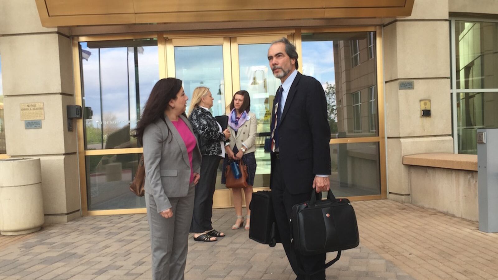 Lawyers for the Jefferson County Education Association Kris Gomez, left, and Michael Belo talk outside the Jefferson County courthouse in Golden. Belo argued the county's school board overreached when it established a new pay system for teachers.