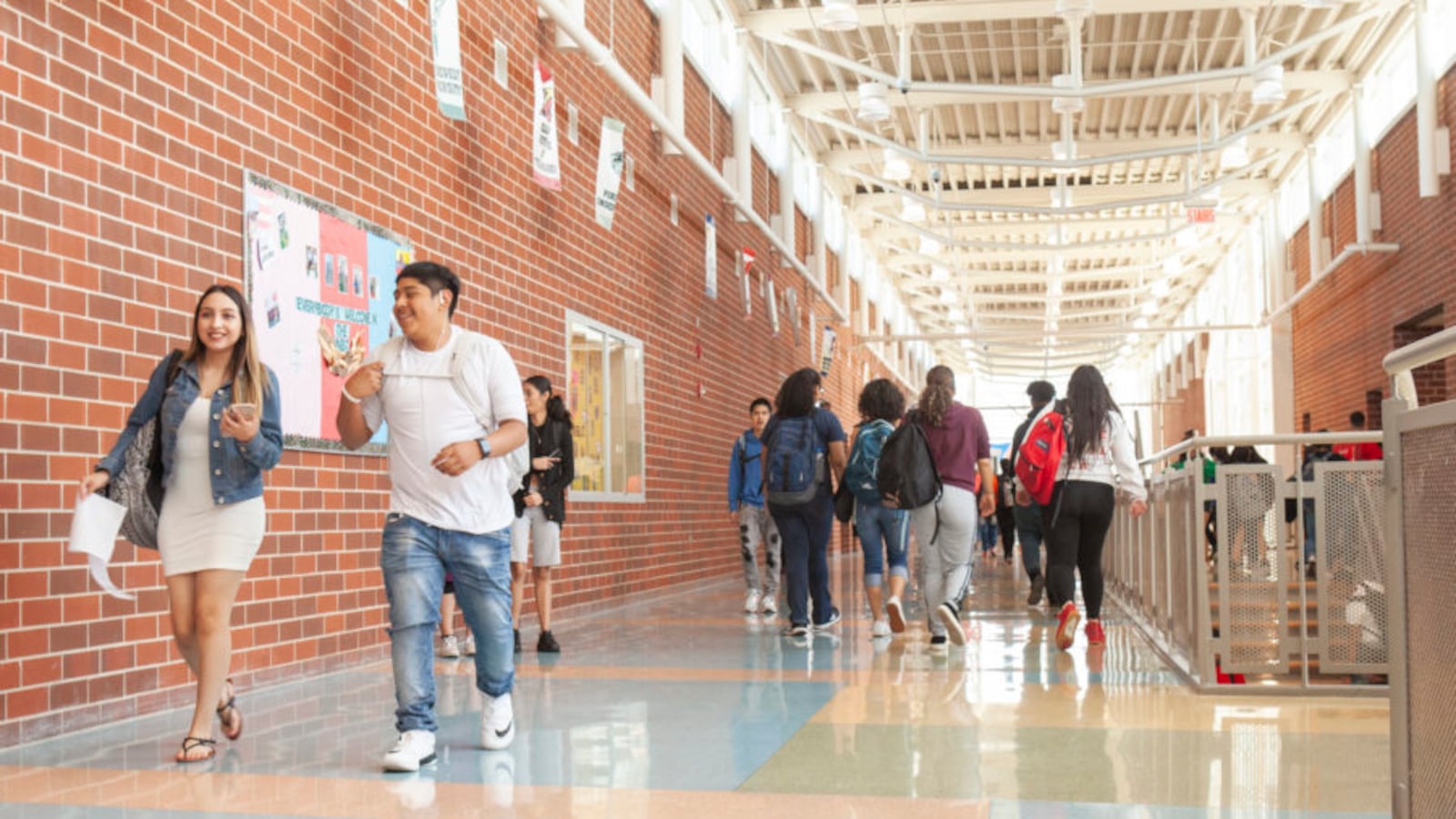 Students walk through a school hallway.