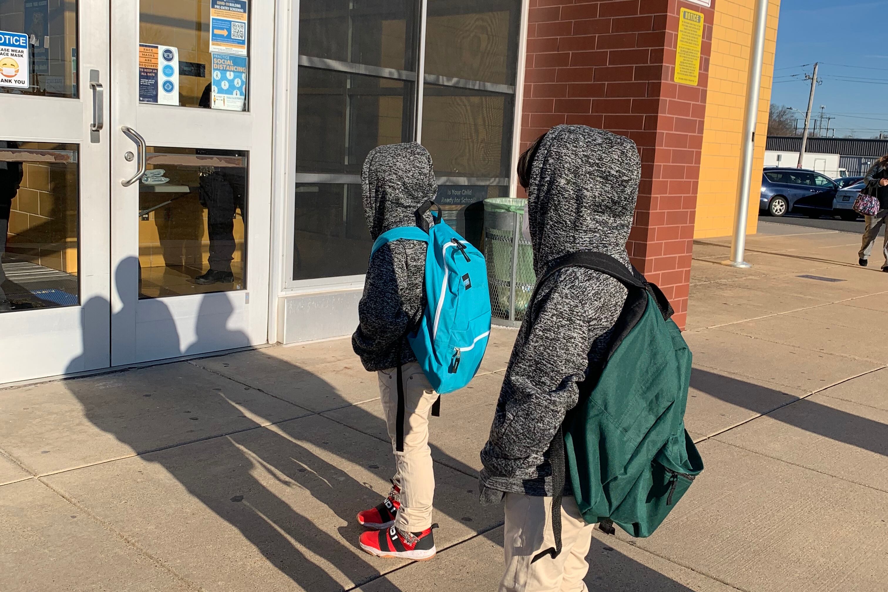Students with backpacks outside school