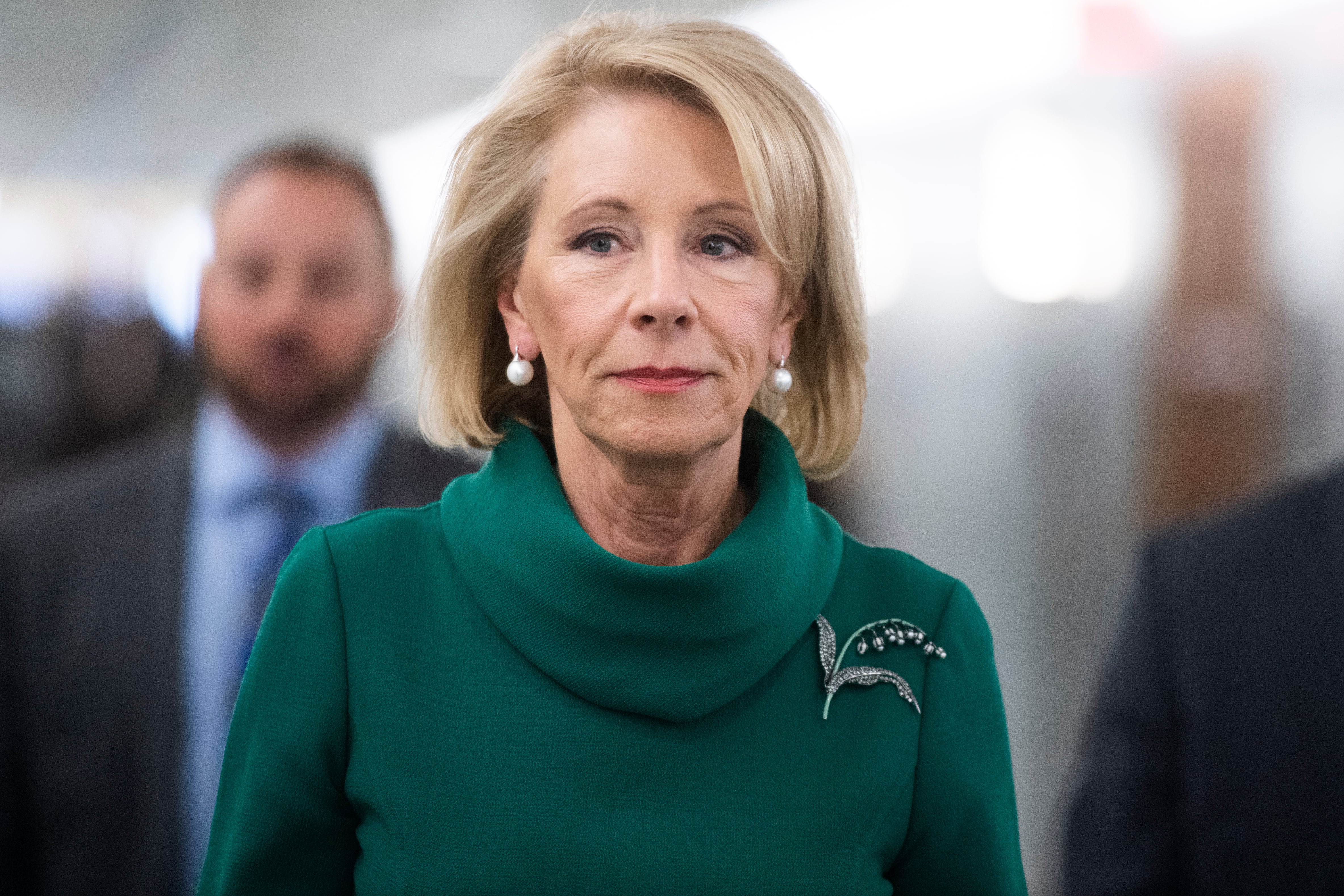 A photo of Betsy DeVos, the former U.S. Education Secretary, walking to a Congressional hearing.