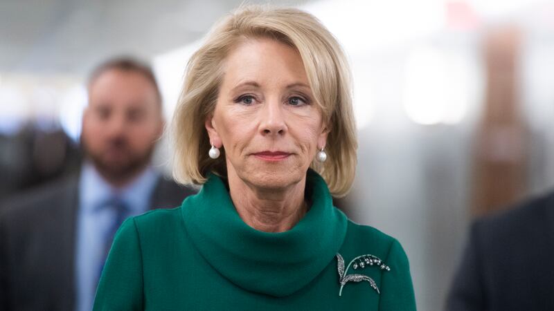 A photo of Betsy DeVos, the former U.S. Education Secretary, walking to a Congressional hearing.
