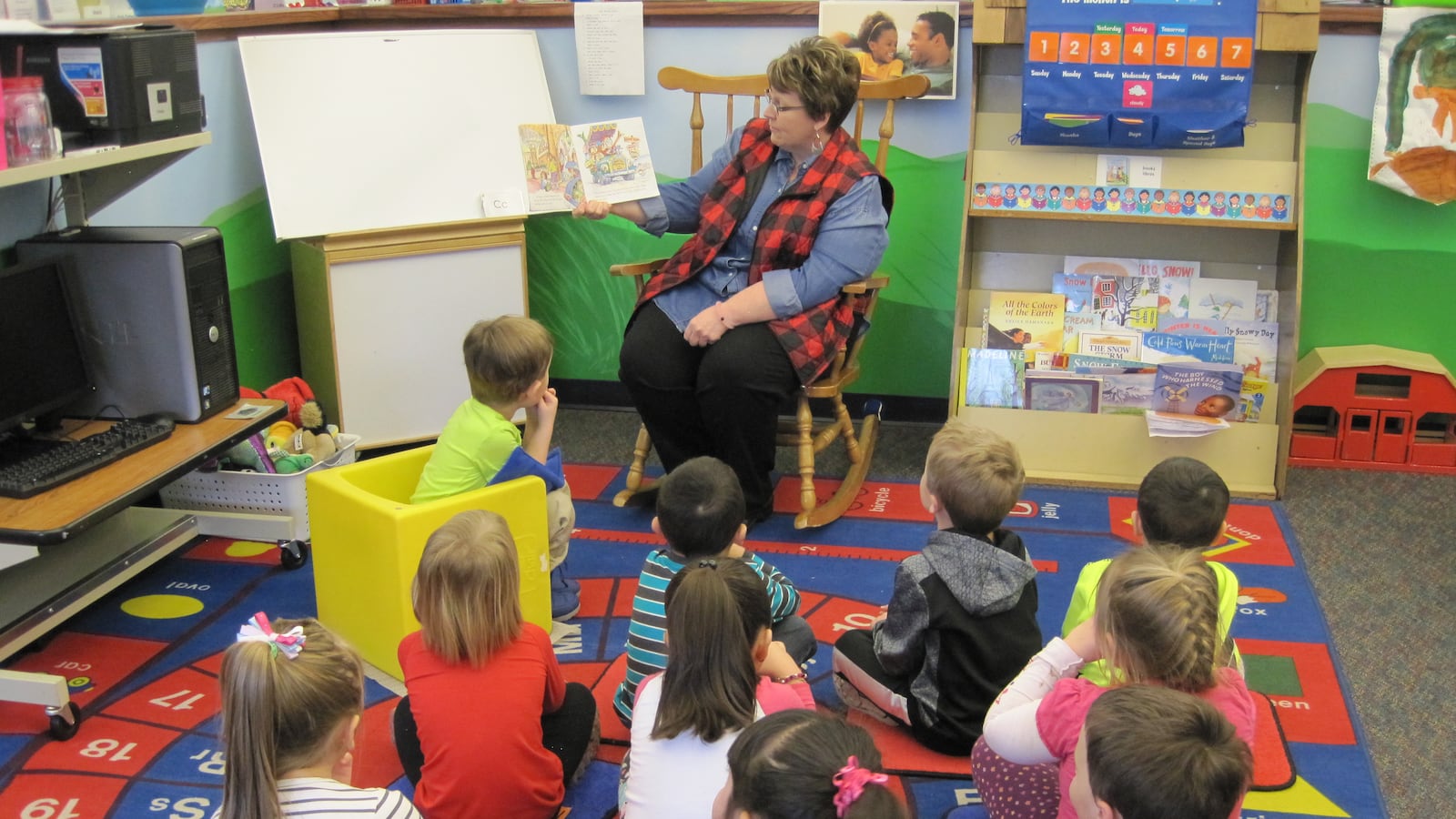 Marcia Walter, a teacher and the director at Dragon's Wagon Preschool, reads to her students.