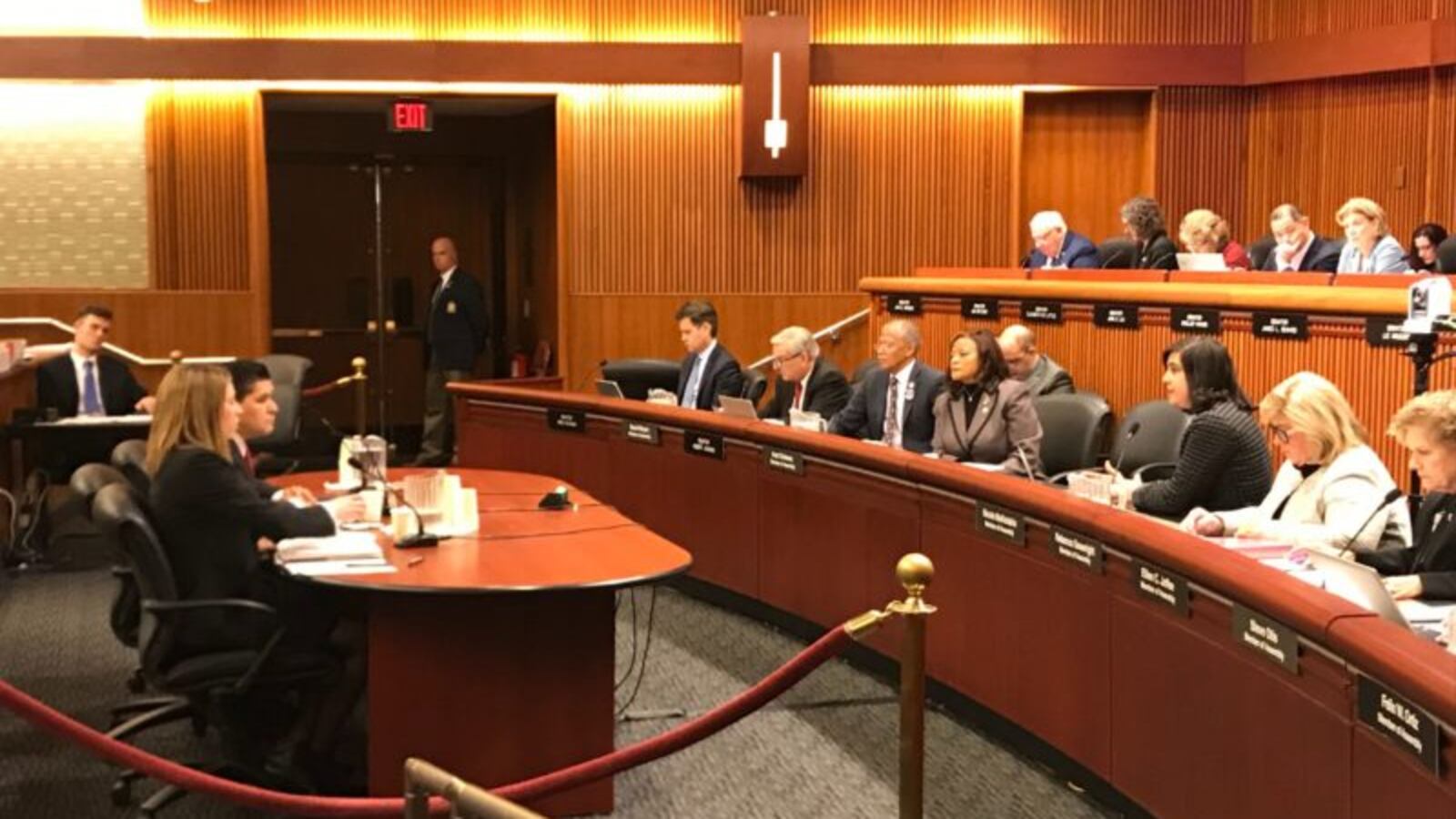 New York City schools Chancellor Richard Carranza, seated at the table, addresses state lawmakers in Albany. To his right, Lindsey Oates, chief financial officer of the New York City Department of Education.