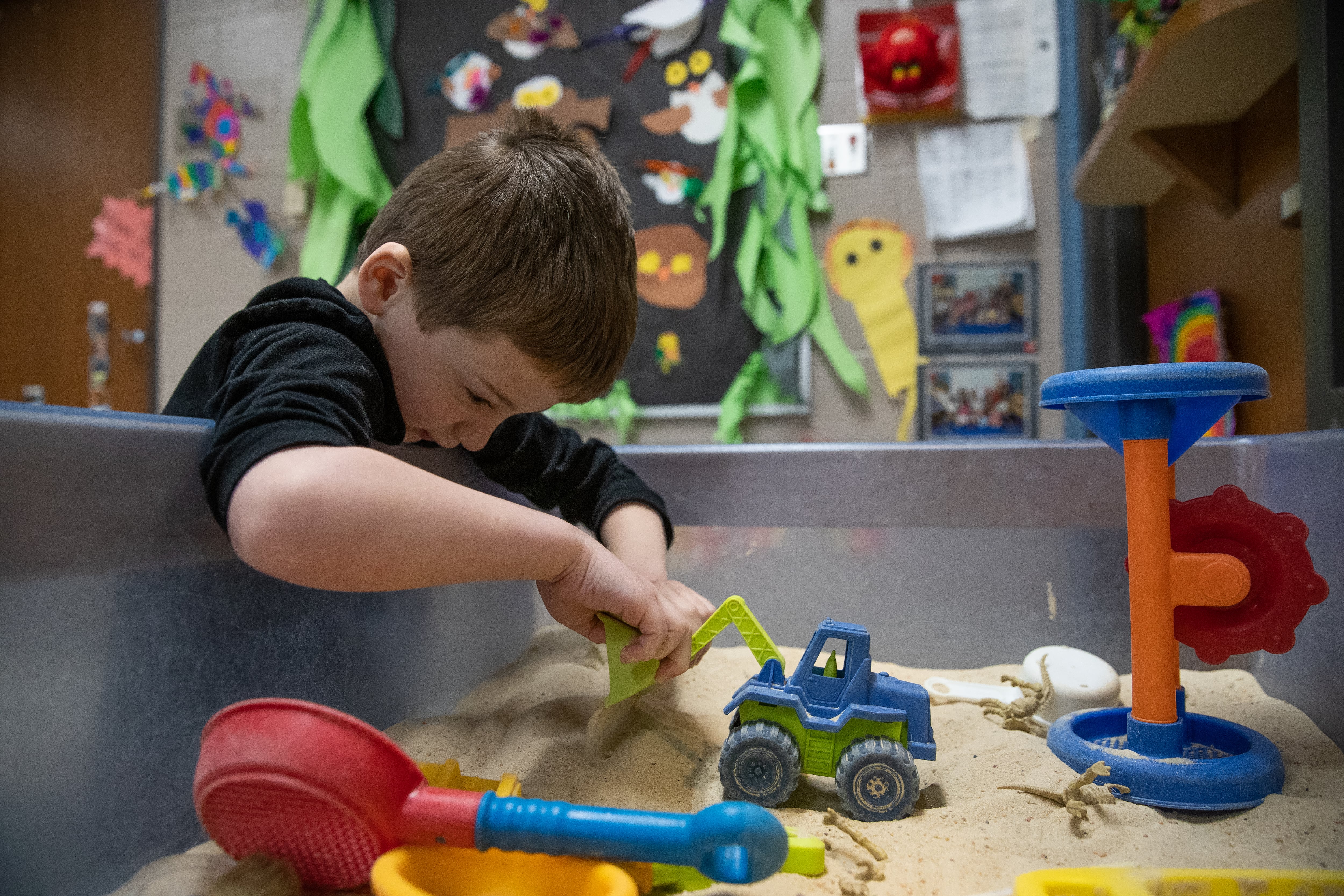 Zander Madsen, 5, digs in the sandbox inside Allison Kempers’ pre-kindergarten classroom on Thursday, April 18, 2019.