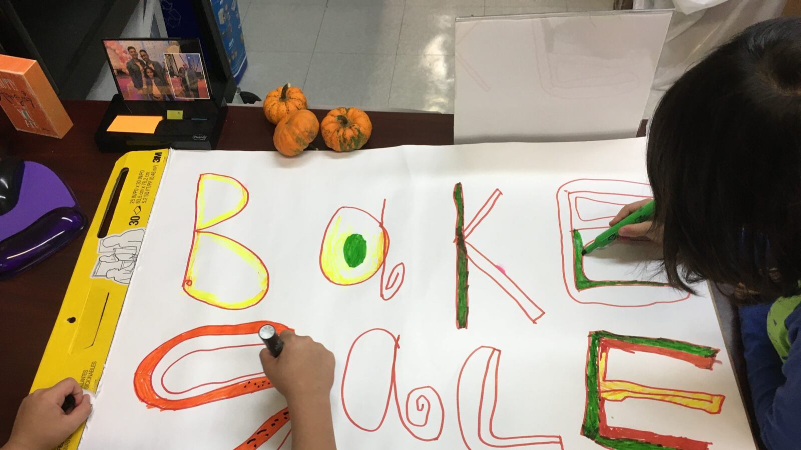 Children help color a bake sale sign for a PTA fundraiser at New York City’s P.S. 165.