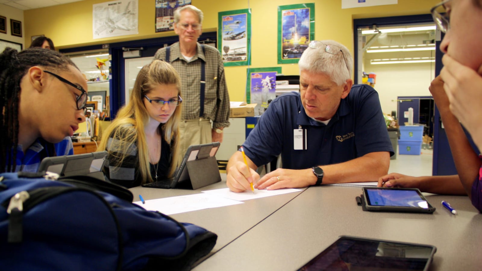 Students in Decatur Township work on physics problems with their teacher.