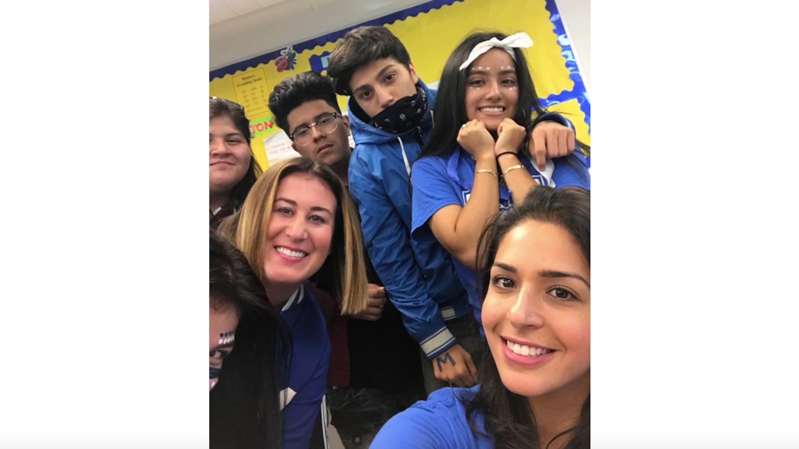Hyam Elsaharty, bottom right, a teacher at Mather High School in Chicago, poses in 2018 with her students at homecoming.