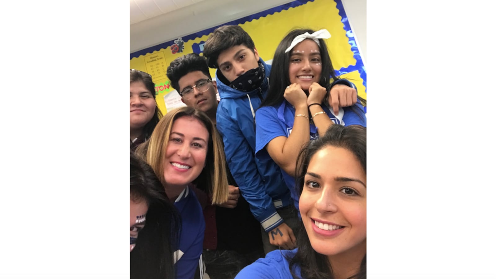 Hyam Elsaharty, bottom right, a teacher at Mather High School in Chicago, poses in 2018 with her students at homecoming.