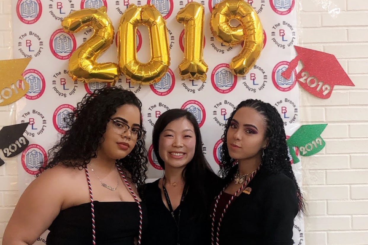 Nancy Yeh, center, poses with two of her students to celebrate College Decision Day. Decorations and gold balloons denote the year 2019.
