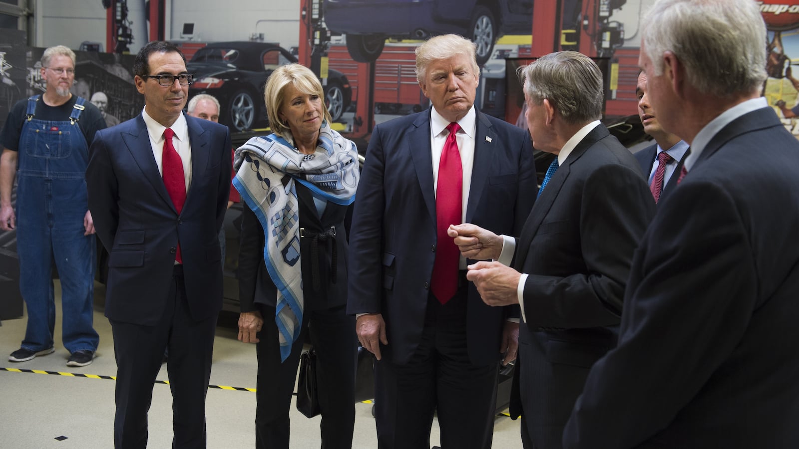 US President Donald Trump tours Snap-On Tools alongside Snap-On CEO Nick Pinchuk (2nd R), Secretary of Treasury Steve Mnuchin (L) and Secretary of Education Betsy DeVos (2nd L) in Kenosha, Wisconsin, April 18, 2017, prior to signing the Buy American, Hire American Executive Order. (Photo credit: SAUL LOEB/AFP/Getty Images)