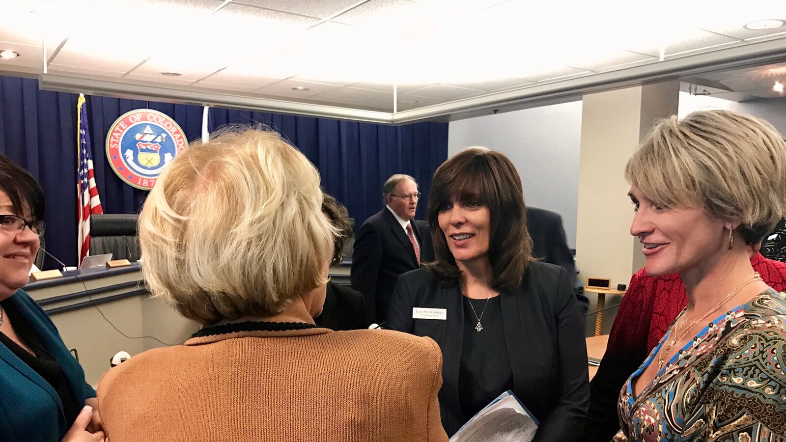 Montezuma-Cortez Superintendent Lori Haukeness, center, speaks with state board chairwoman Angelika Schroeder after Thursday's meeting.