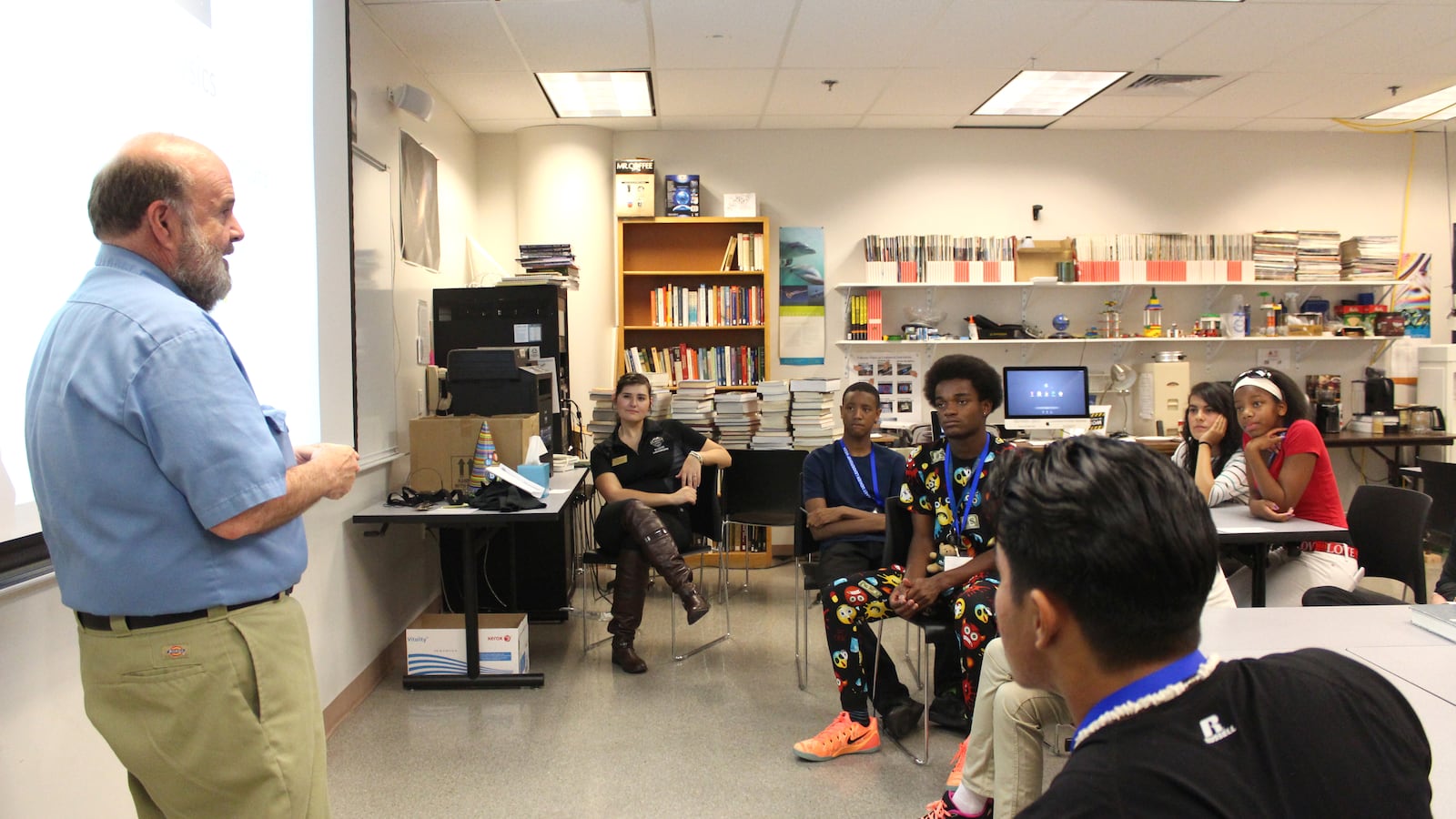 Students look on as a CU Denver physics instructor talks to them about physics and space. Physics was one of six majors students could explore during breakout sessions.