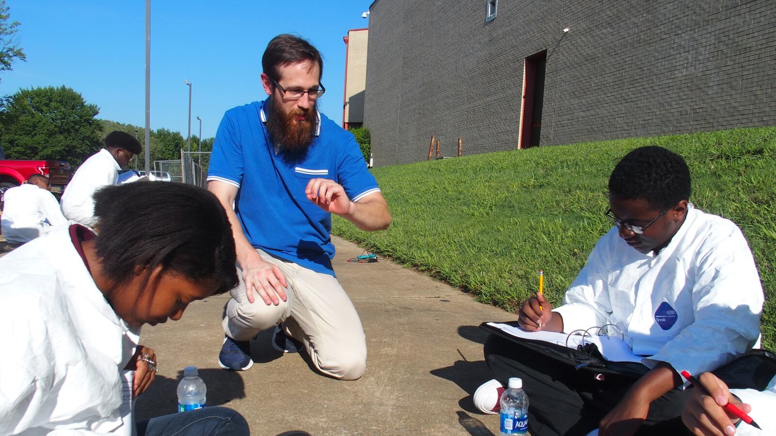 Craigmont High School teacher Wayne Oellig helps his students with a biology experiment related to the Aug. 21 solar eclipse.