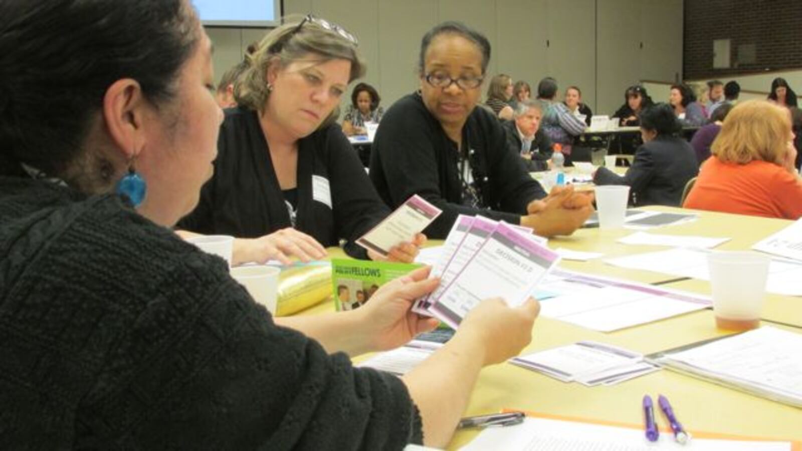 Arsenal Tech High School science teacher Elvia Solis works through teacher pay options with Sue Leibrock, a fifth grade teacher at School 31, and Jacki Sababu, a special education monitor for IPS, at a TeachPlus event Wednesday. (Scott Elliott)