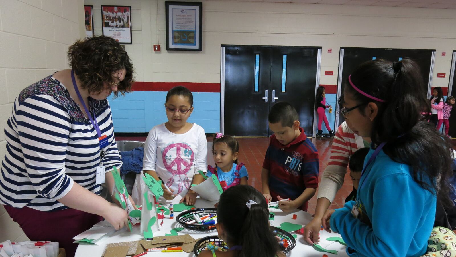 Students participate in a craft at a joint event between Metropolitan Nashville Public Schools and the Nashville Public Library to teach immigrant families about the public library system.