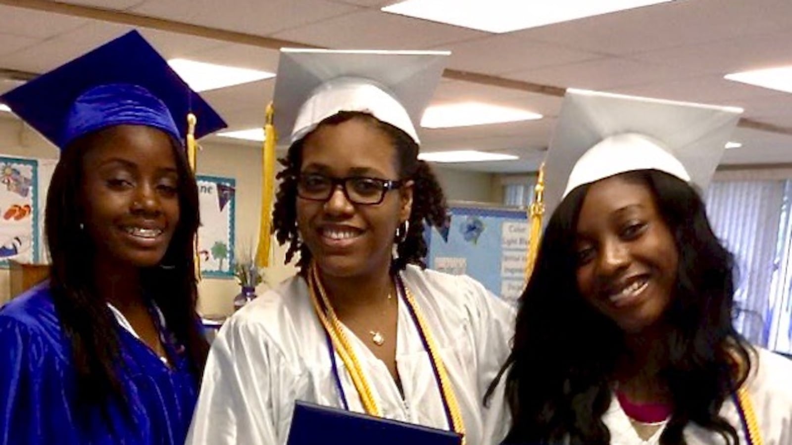 Samantha Smylie, center, and friends graduate from Chicago's John Hope College Prep High School in summer  2013.