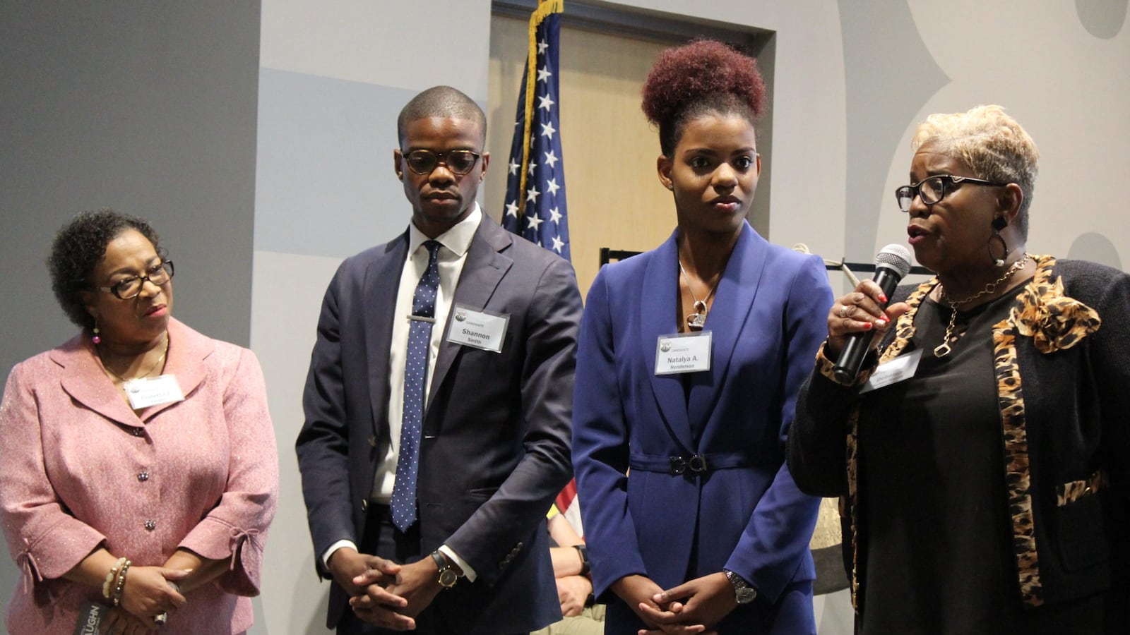 Deborah Hunter-Harvill, the lone incumbent running for school board, makes an opening statement. Candidates made one-minute opening statements, then rotated through a roomful of 130 people answering questions about their plans for the district. From left: Corletta Vaughn, Shannon Smith, Natalya Henderson, Hunter-Harvill.