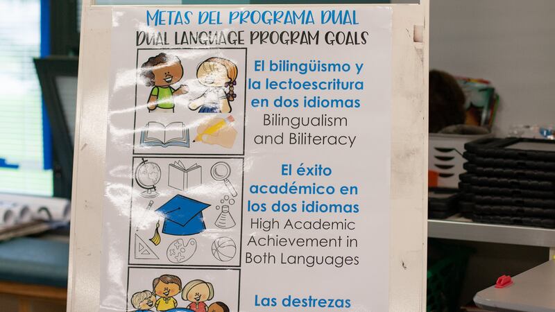 A sign in a bilingual classroom at Harrison Hill Elementary School explains the goals of the school’s dual language program. Some IPS parents want to see policies that would add more bilingual staff to schools in order to better allow families to engage in day-to-day communication. 