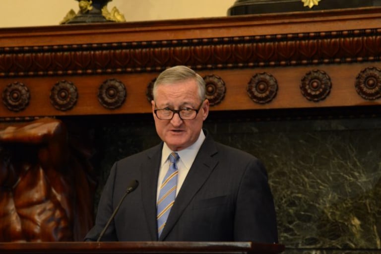 Philadelphia Mayor Jim Kenney making an announcement at a podium.