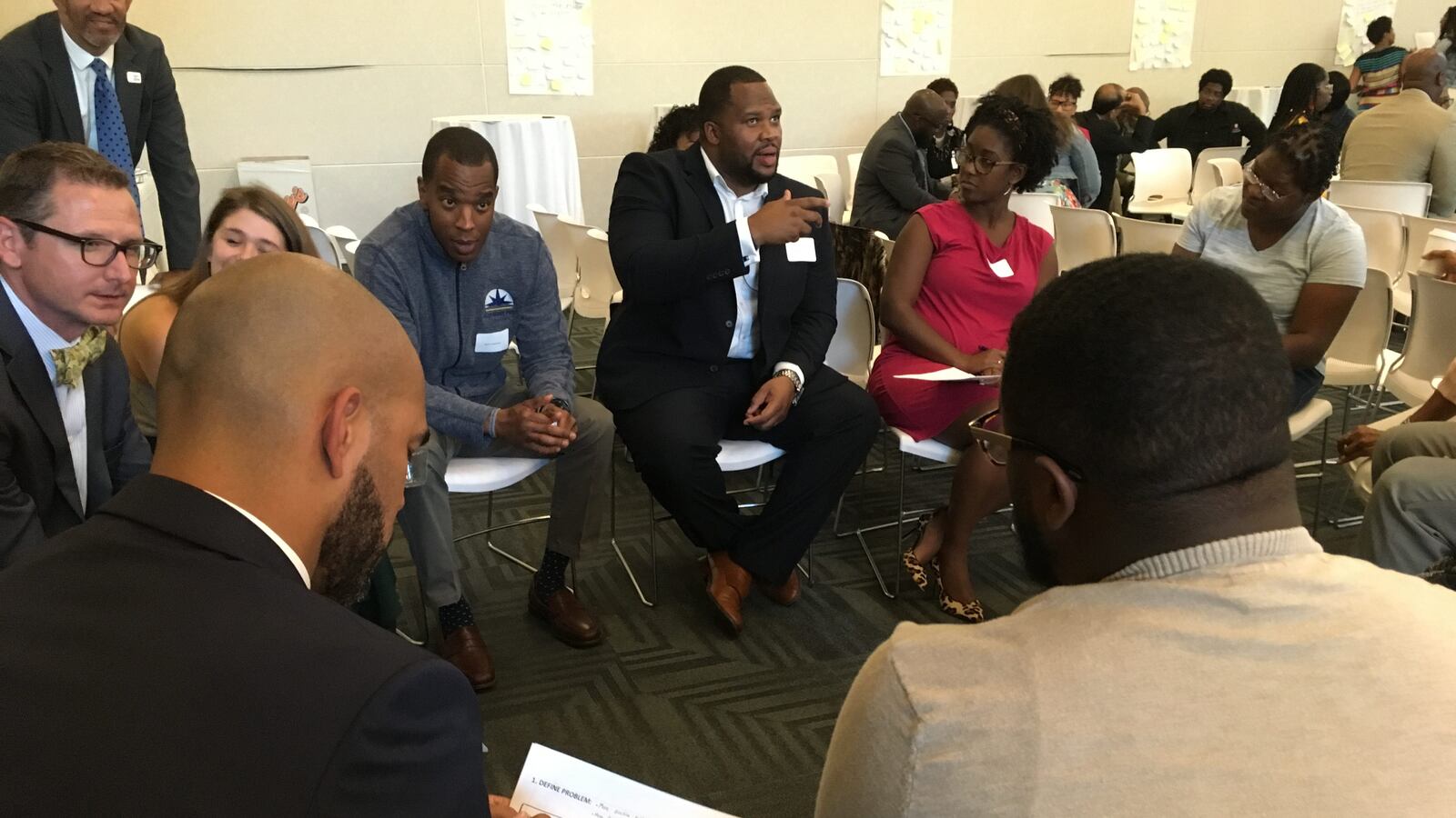 Educators work in small groups to brainstorm solutions to challenges facing educators of color at a Marian University event Thursday night.