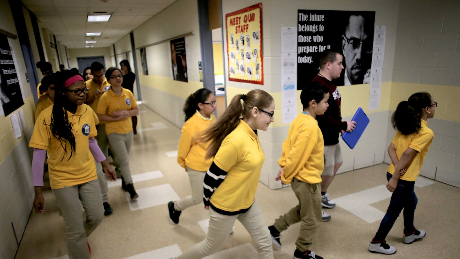 Students transition to gym class from Zoe Pierce's sixth grade science class at the Impact School in Springfield, Massachusetts in January 2017. Working with state officials, Springfield education leaders have crafted a first-of-its-kind plan for a Massachusetts school system, spinning off the middle schools into what effectively is their own miniature school system.