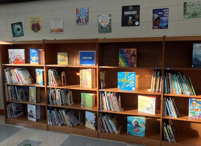 A photograph of a bookshelf in a school library.