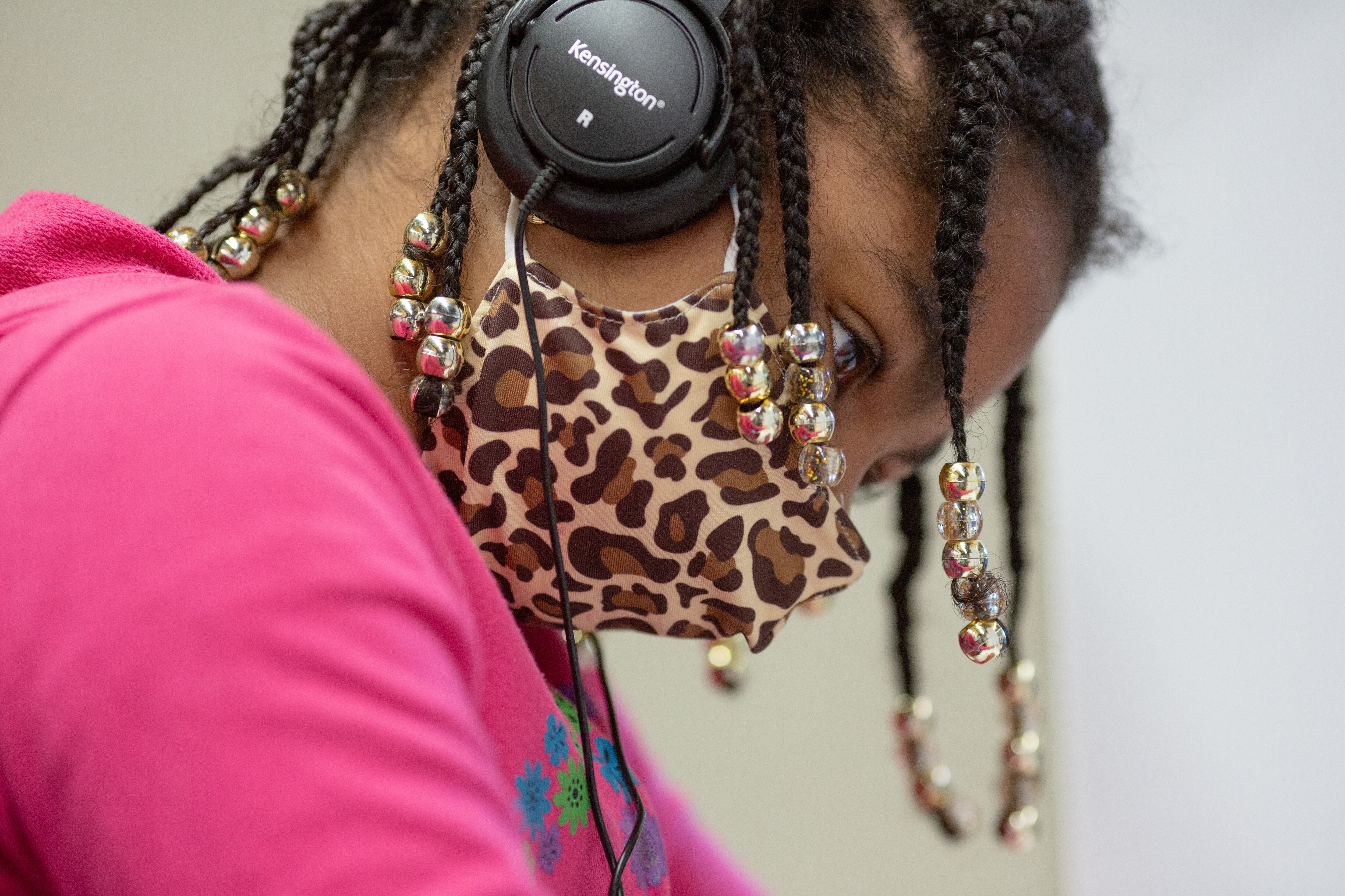Close up of a student wearing a mask and headphones.