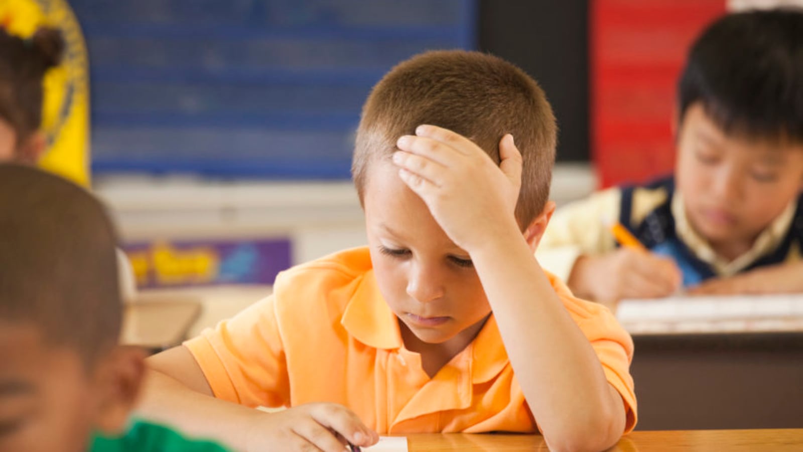 Student studying at desk in classroom.