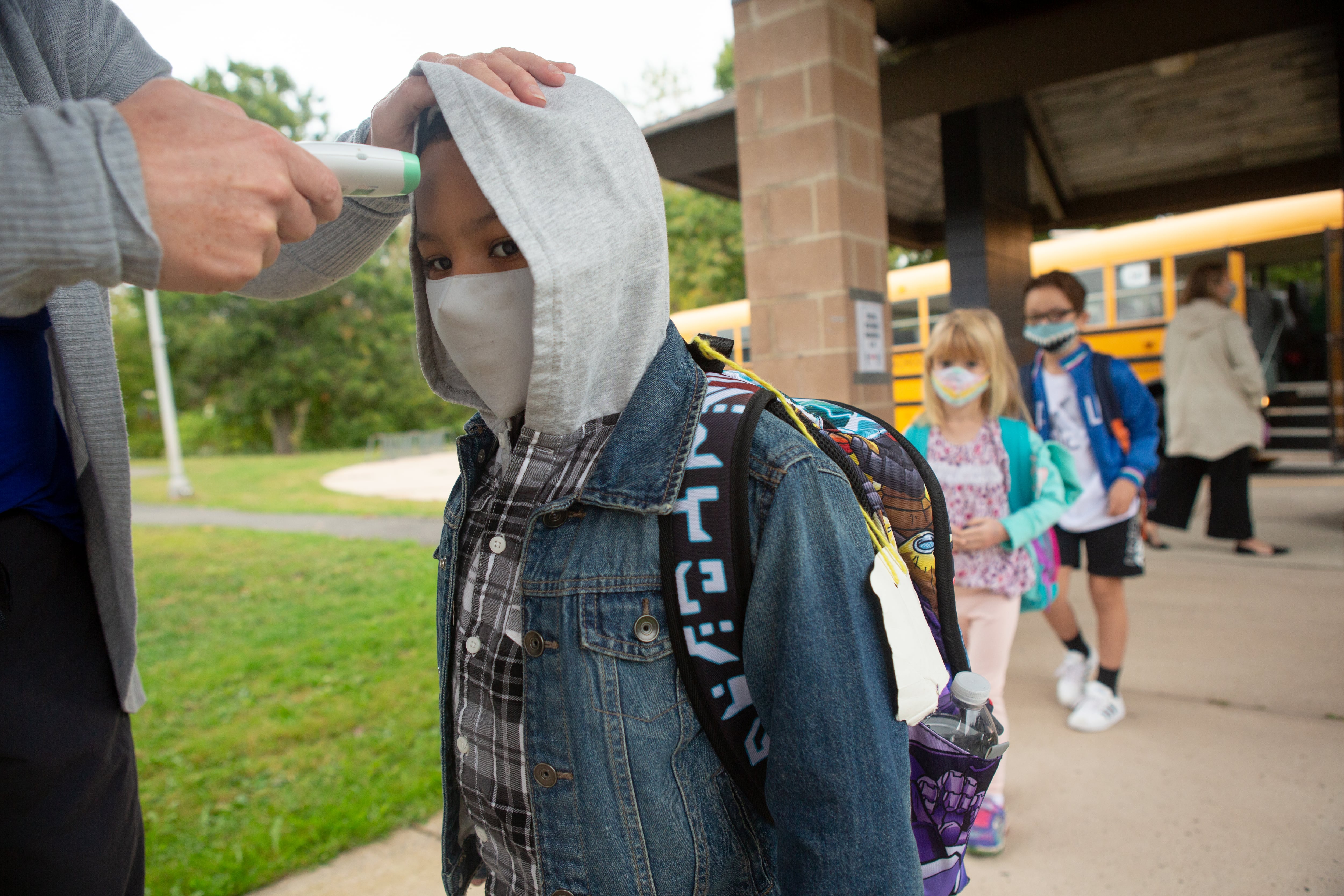Students are giving temperature checks by the school nurse before being allowed into the building at Wesley Elementary School in Middletown, CT, October 5, 2020.